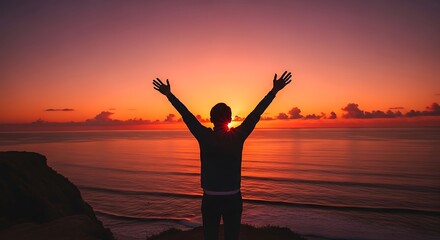 Fototapeta premium Man standing on beach at sunset.