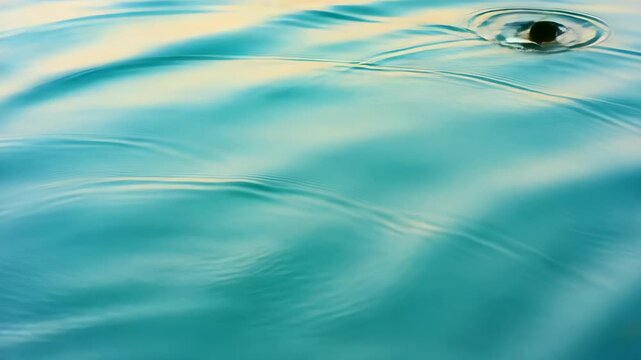 Abstract close-up view of turquoise water surface ripples and gentle wave patterns creating a serene and reflective natural background