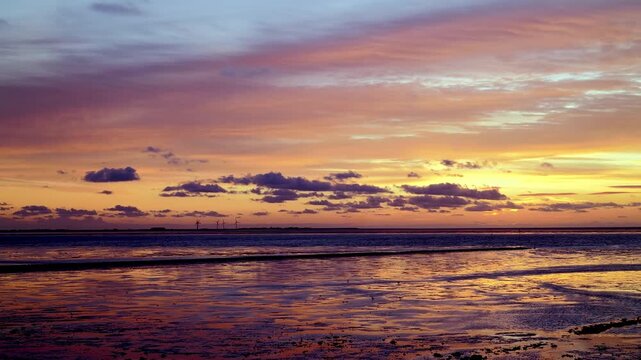 Sunset at Norderhafen (northern harbor) of the Nordstrand peninsula at the Wadden Sea National Park in Schleswig-Holstein, Germany, Europe
