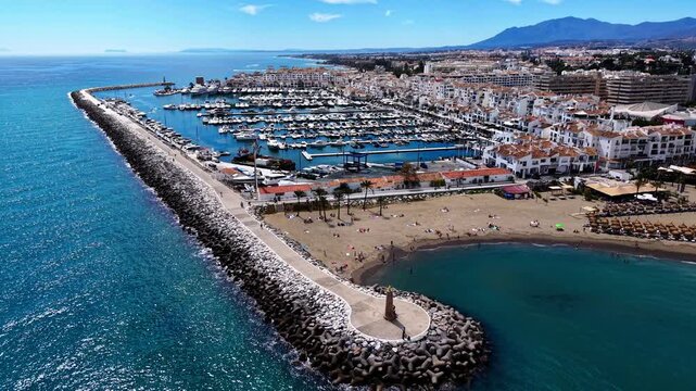 Puerto Ban&uacute;s marina video, aerial drone view of harbor, beach and coastline in Marbella, Spain