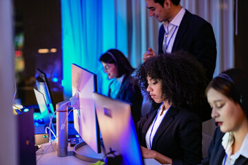 Successful diverse professionals analyzing real-time metrics and software solutions. Technical...