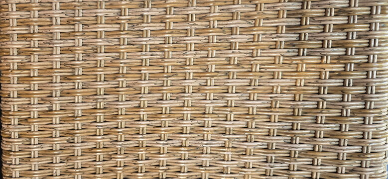 Woven rattan pattern, rattan furniture, texture background, light brown, close-up. Artificial rattan pattern (Synthetic rattan).Background of basket structure close-up. Furniture backdrop
