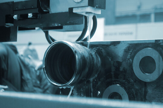 Wire-cut electrical discharge machine. Operation of wire-EDM machine cutting metal parts. Electrical discharge machine EDM cutting metal workpiece. Cutting process by wire cut machine. Metalworking