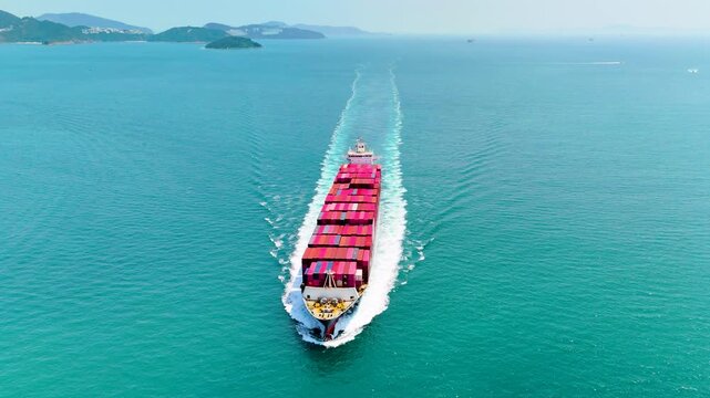 Giant container ship heavy ship goes on water with a lot of cargo in the sea strait when entering the port, view top straight air from above
