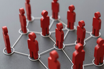 Obraz premium A group of business people connected and linked to each other. The more important a person is, the more links they have, and the closer they are to the center.