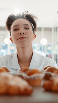 Woman, chef and tray with muffins at bakery with walk, cooking and preparation at confectionery store. Person, pastry and baker with cake for order, process and cuisine with dessert at restaurant