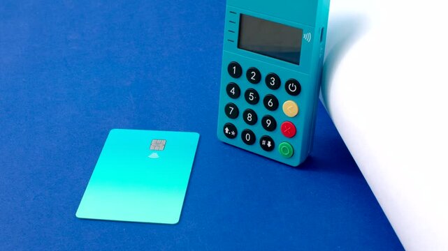 Mini blue card machine on a flawless surface, perfect for hassle-free transactions. The mini blue card machine rests elegantly on a smooth surface, promoting streamlined transactions.