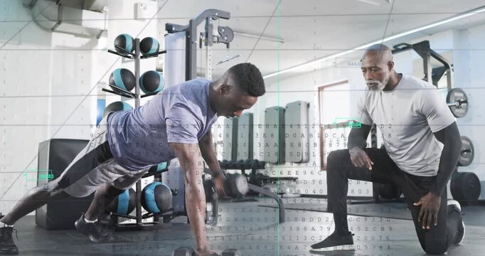 Coach cueing trainee doing alternate dumbbell rows in plank for fitness while teal graphs appearing