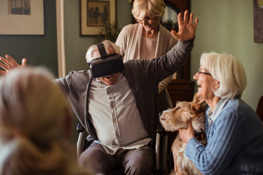 Seniors exploring virtual reality together at home