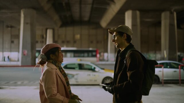 Two smiling tourists exchange a high-five while navigating a bustling city street with a map. A joyful moment between travelers exploring an urban environment.