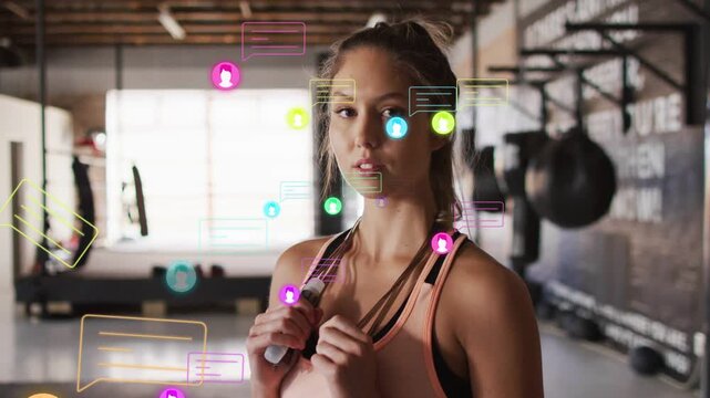 Reacting to floating overlays woman in peach top tightening rope grip and shifting head in gym