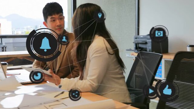 Man sitting while woman manipulating tablet, overlay icons growing, she walking to printer office