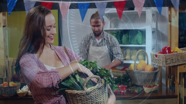 Lens overlay appearing, woman arranging basket greens and man sorting produce for market display