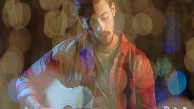 Music acoustic guitarist starting playing shifting frets camera pulling back bokeh framing face