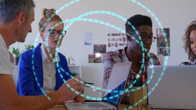 Design team gesturing and pointing at laptops, pen initiating cyan spiral overlaying team growing