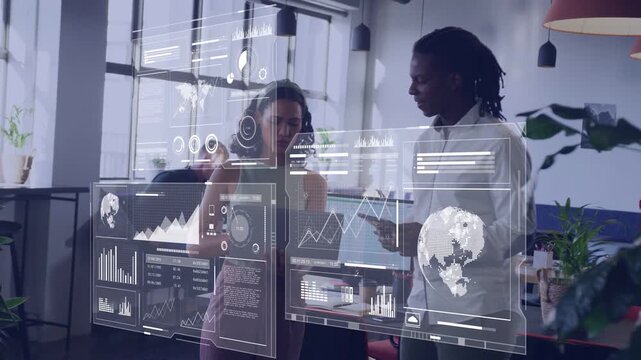 Woman tapping laptop causing holo charts shifting, man pointing tablet analyzing business data