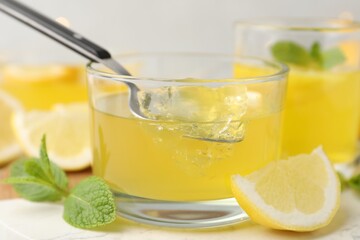 Fototapeta premium Lemon jelly served with mint on table, closeup