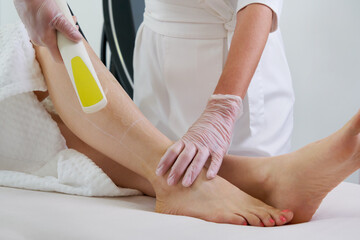 Fototapeta premium Woman in professional beauty clinic during laser hair removal