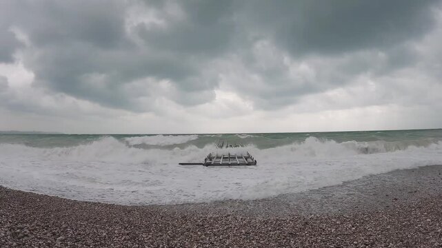 Ocean waves crashing into abandoned pier