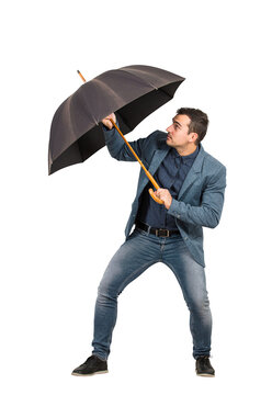 Full length determined businessman hiding behind his open umbrella as a protection shield from danger, isolated on transparent background. Business concept of facing adversity and defending