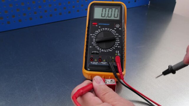 Measuring the voltage of alkaline batteries using a digital multimeter.