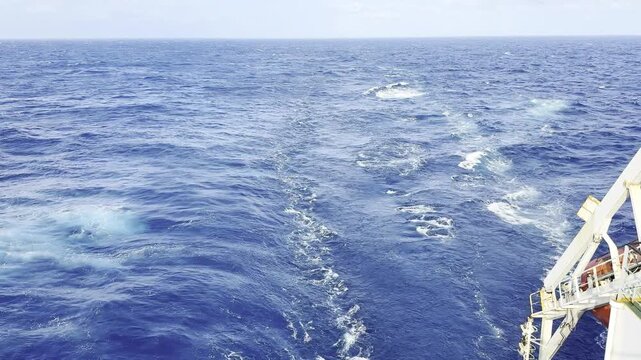 Dramatic colliding swells rise high into millions of sparkling drops carried by gale winds emphasizing fierce aquatic beauty remote open sea environment demonstrating unstoppable environmental forces