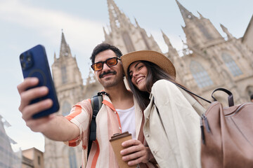 Happy tourists taking selfie in barcelona city © alvaro