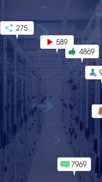 Central aisle past tech racks, blue arrows moving left spawning alert bubbles updating counters