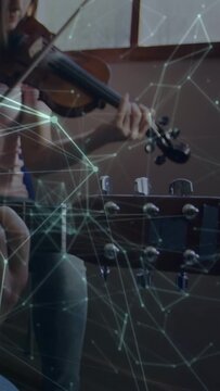 Camera pulling back while teen violinist practicing music by window, overlay crossing headstock