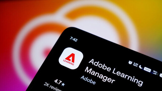 Closeup of a smartphone screen displaying the adobe learning manager app icon and name