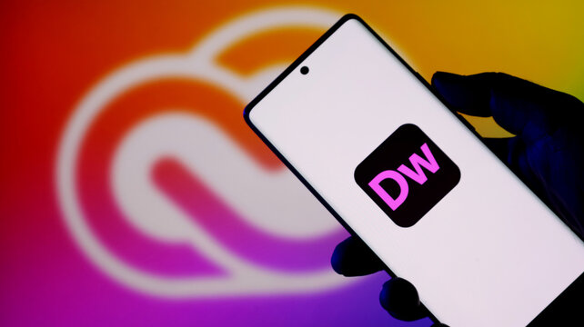 Closeup of a smartphone displaying the adobe dreamweaver app icon