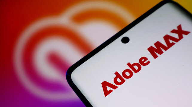 Closeup of a smartphone screen displaying the adobe max logo