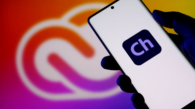 Hand holding a smartphone displaying the adobe character animator app icon