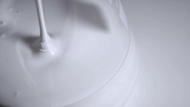 White paint into a glass container