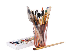 Fototapeta premium Paintbrushes with knife in glass and paints isolated on white