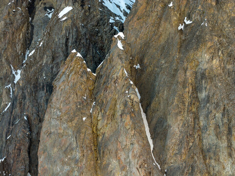 Rocky Mountain Cliff Face With Snow Patches and Dramatic Texture in BC Canada