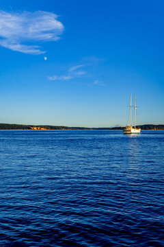 Sailboat on Puget Sound near Port Townsend Washington early morning with the moon