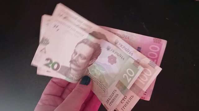 Stock video of a hand holding Ukrainian currency