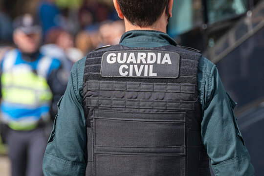 Guardia Civil officer back view with tactical vest The Concept of safety and law