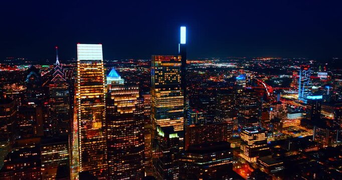 Neon lights on the tops of the gorgeous skyscrapers. Iconic scenery of Philadelphia, Pennsylvania, USA at night.