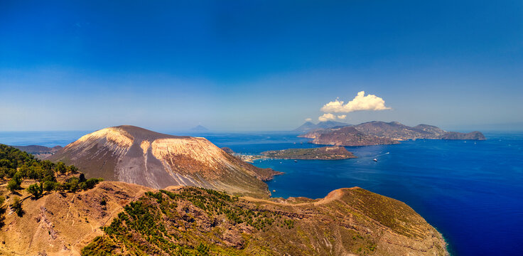 Aerial view of Vulcano island with its large crater and rugged slopes overlooking the blue Mediterranean Sea in Lipari, Sicily, Italy.
