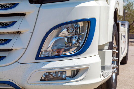 White truck with blue-accented headlights