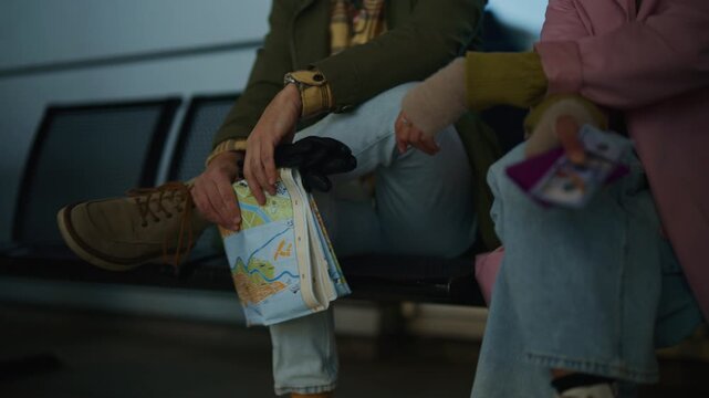 Two young tourists attentively study a folded city map. They are planning their next urban exploration adventure.