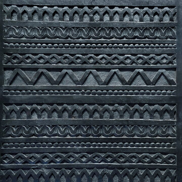 Dark geometric relief pattern wood texture background