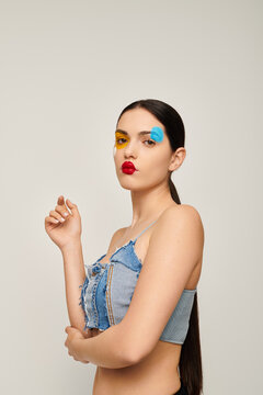 Vibrant face art transforms a young womans style with bold colors and confidence