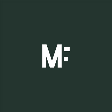 White letter M with colon on dark green background