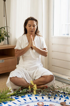 Woman meditating around a mandala circle