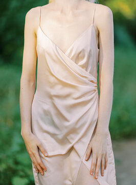 blond woman wearing silk classic dress outdoors