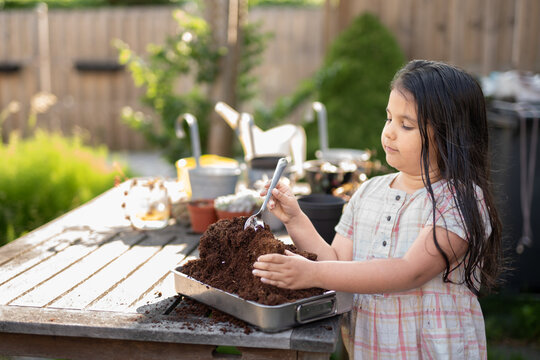 Girl playing with soil for planting