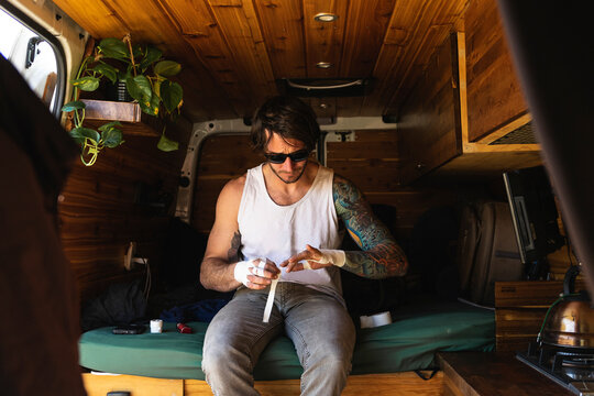 Climber taping his hands camper van